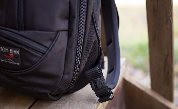 A Black Strap Keeper holding a shoulder strap's rolled excess length out in place.